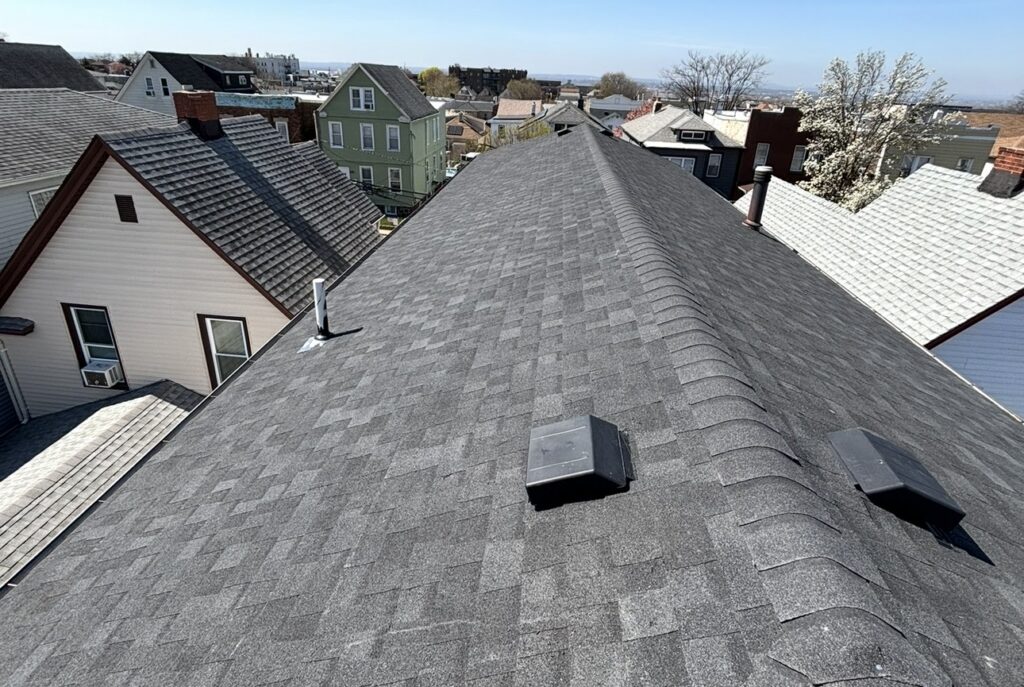 Owens Corning shingle roof addition with wall flashing and vinyl siding detail in Union City, NJ — Gaby Roofing Flat Roof Specialist