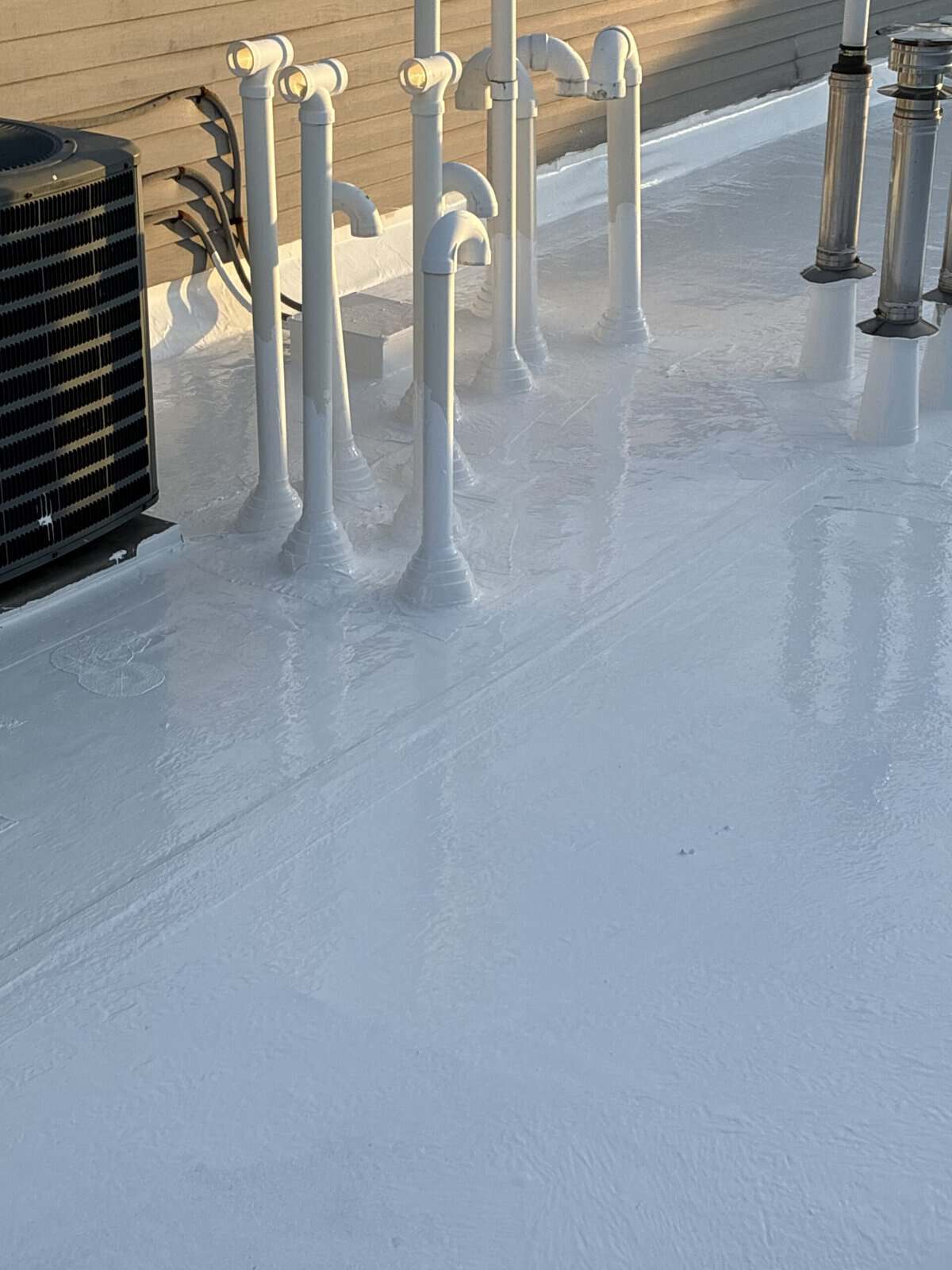 Silicone roof coating pipe penetration detail in NJ — Gaby Roofing flat roof specialist