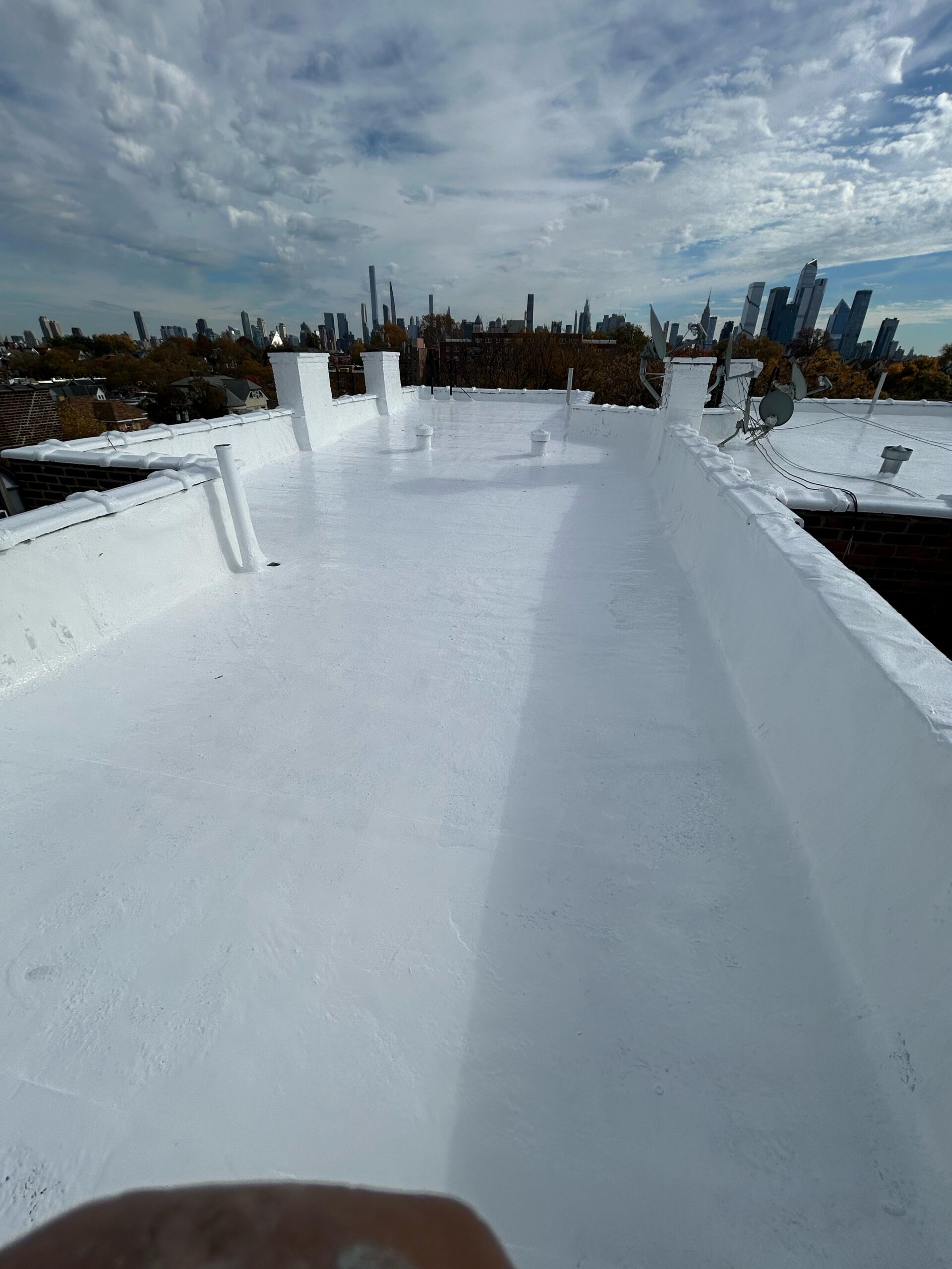 Silicone roof coating installation in North Bergen NJ by Gaby Roofing flat roof specialist