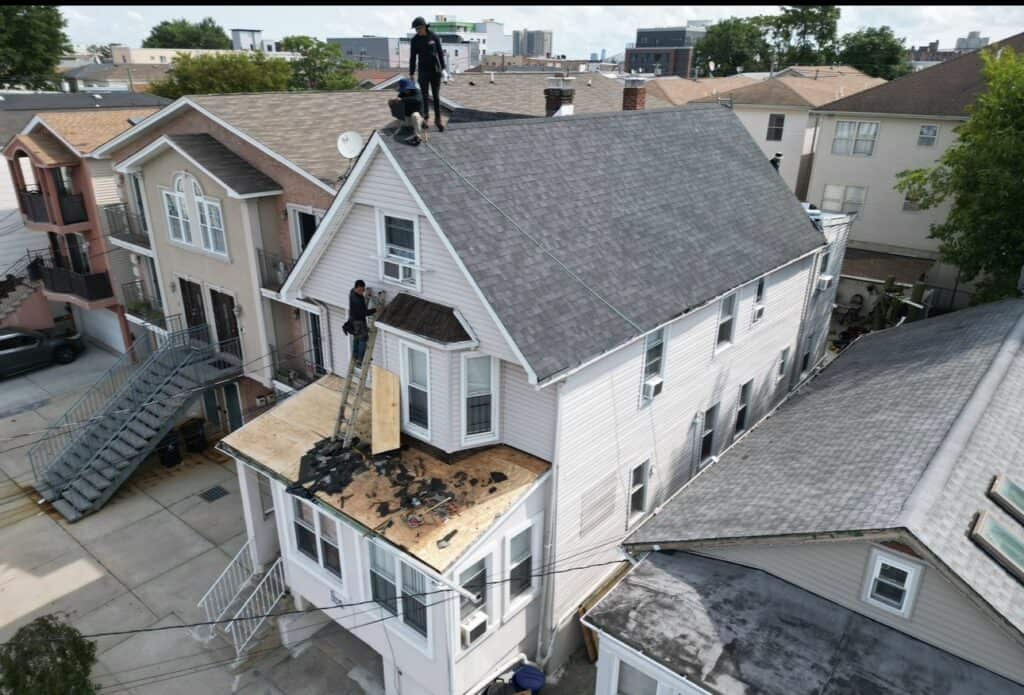 Aged torch-down modified bitumen flat roof on a Hoboken, NJ brownstone — Gaby Roofing inspection
