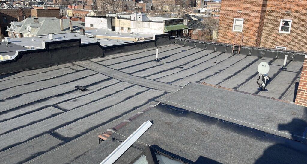 Gaby Roofing crew installing torch-down modified bitumen flat roof in West New York, NJ