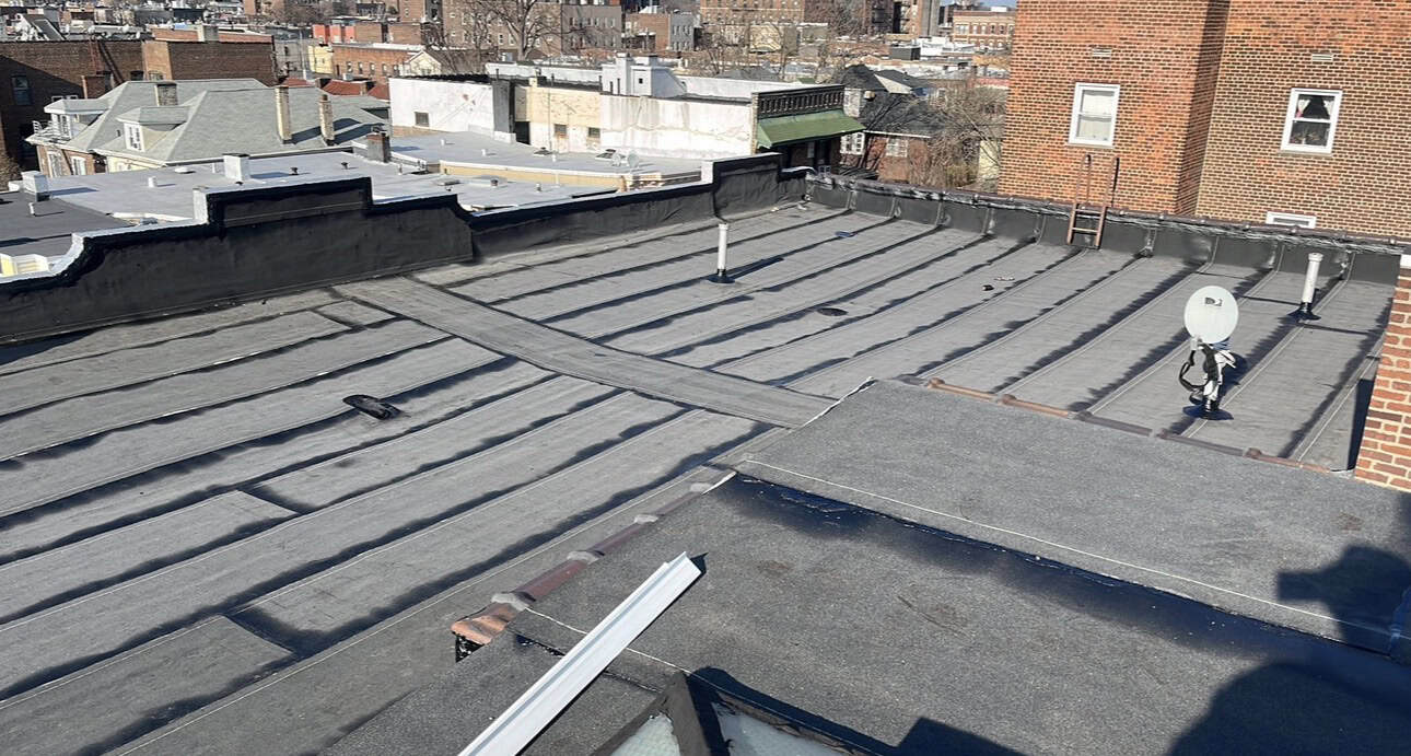 Cuadrilla de Gaby Roofing instalando techo plano torch down en West New York, NJ