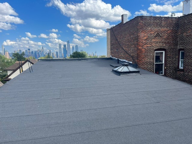 Torch down flat roof installation with skylight in Union City NJ by Gaby Roofing flat roof specialist
