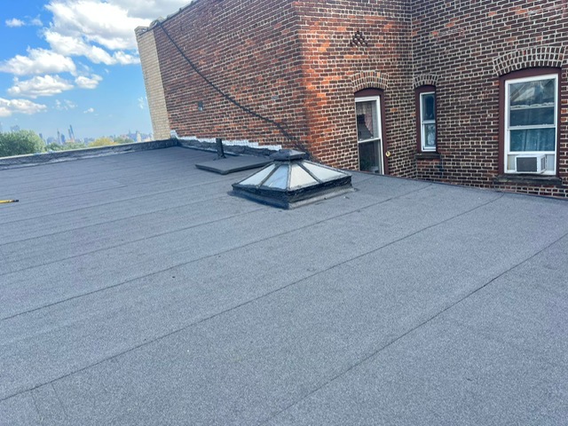 Torch down flat roof with skylight and NYC skyline view in North Jersey by Gaby Roofing