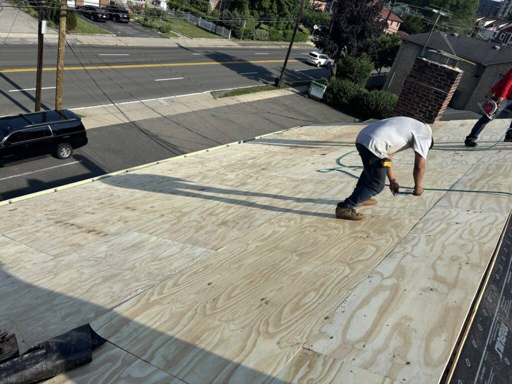 Gaby Roofing crew installing new plywood roof decking during a shingle roof replacement in Bergen County, NJ