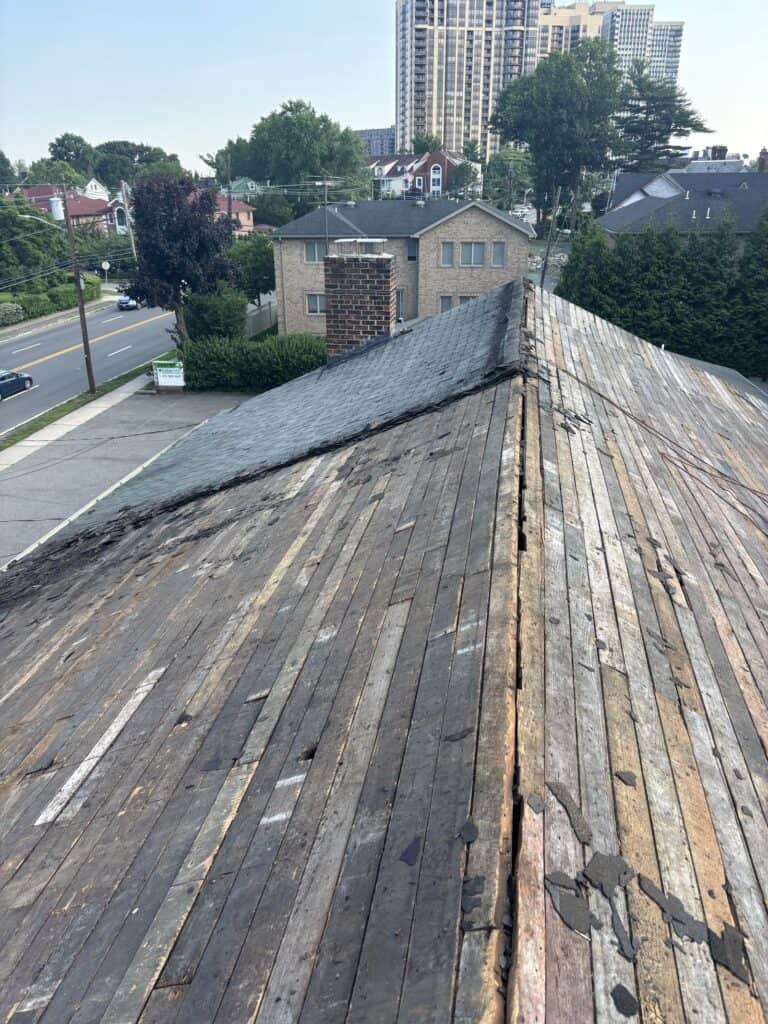 Roof stripped to the wood decking at the ridge during a shingle roof replacement in Bergen County, NJ