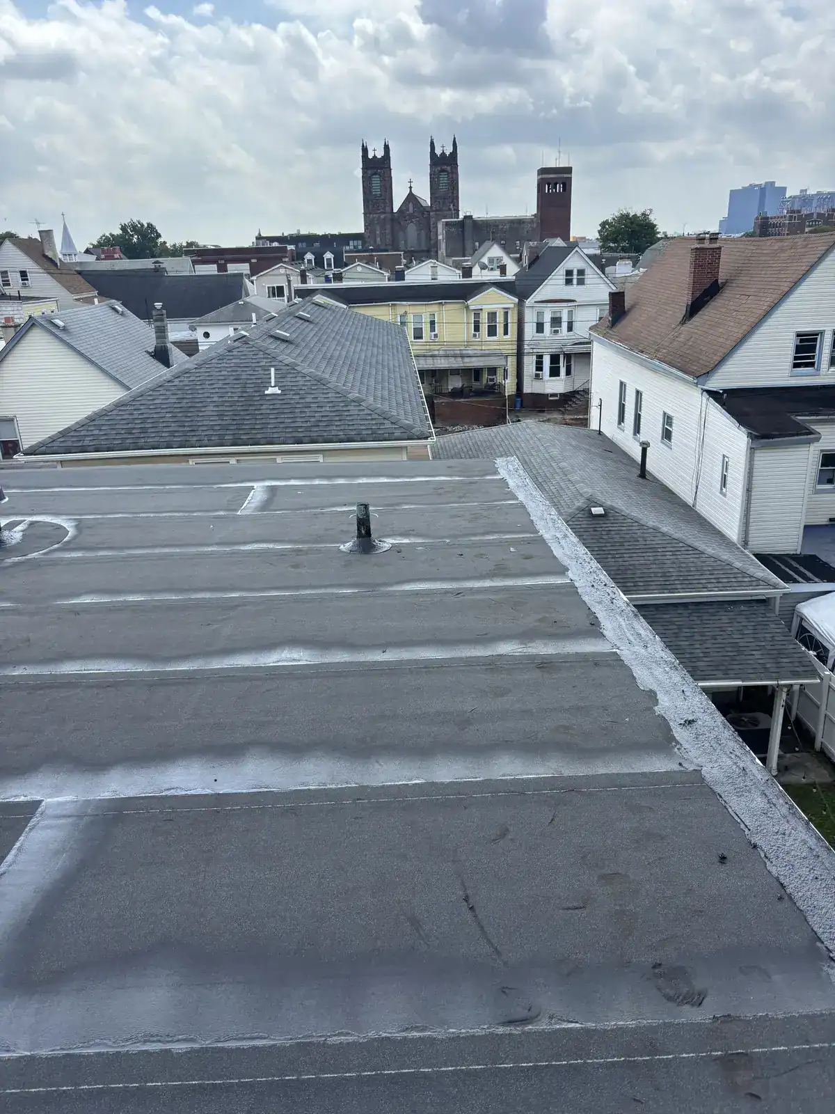 Completed torch down flat roof replacement on a multi-family rowhome in Harrison NJ by Gaby Roofing