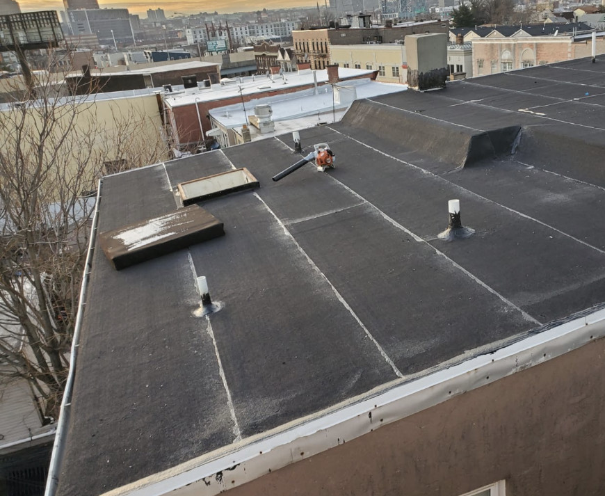 Jersey City local business with a flat roof undergoing professional installation